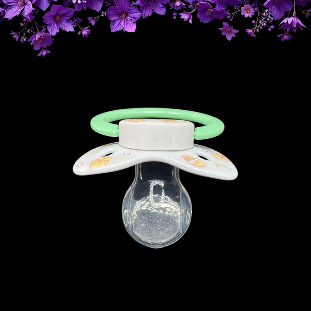 ABDL pacifier featuring a cute yellow duck design on the shield and button, adding a playful and adorable touch.