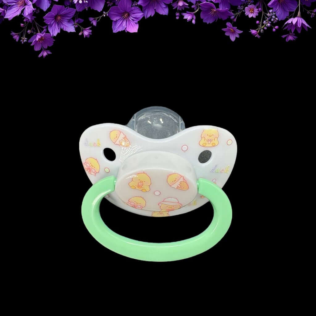 Adult pacifier featuring a cute yellow duck design on the shield and button, adding a playful and adorable touch.