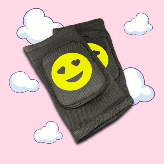 Adult ABDL knee pads designed to mimic baby knee pads, featuring a soft, cheerful design with a smiley face emoji in the center for a playful and youthful look.