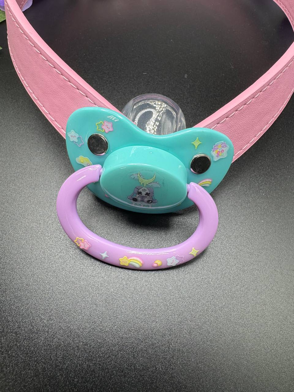 Colorful glow in the dark  pacifier design with a pink strap