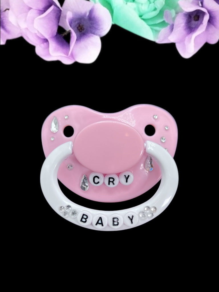 Cry Baby adult deco pacifier featuring a decorative diamond gem design on the shield and handle, adding a stylish and playful touch.
