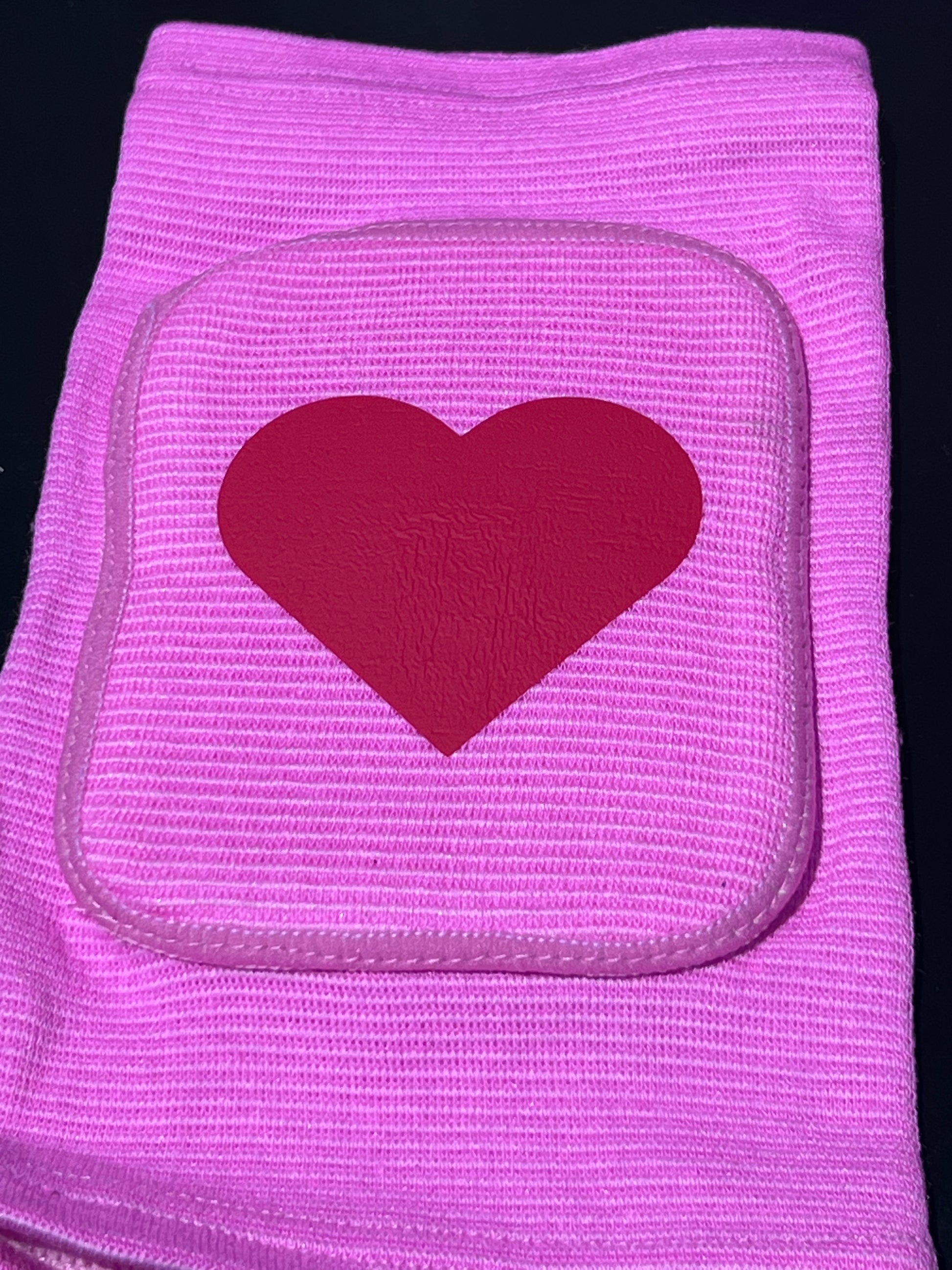Adult knee pads featuring a soft, comfortable design with a heart symbol in the center, adding a sweet and playful touch.