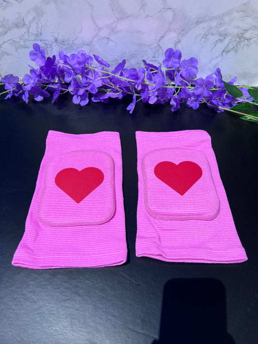 Adult knee pads featuring a soft, comfortable design with a heart symbol in the center, adding a sweet and playful touch.