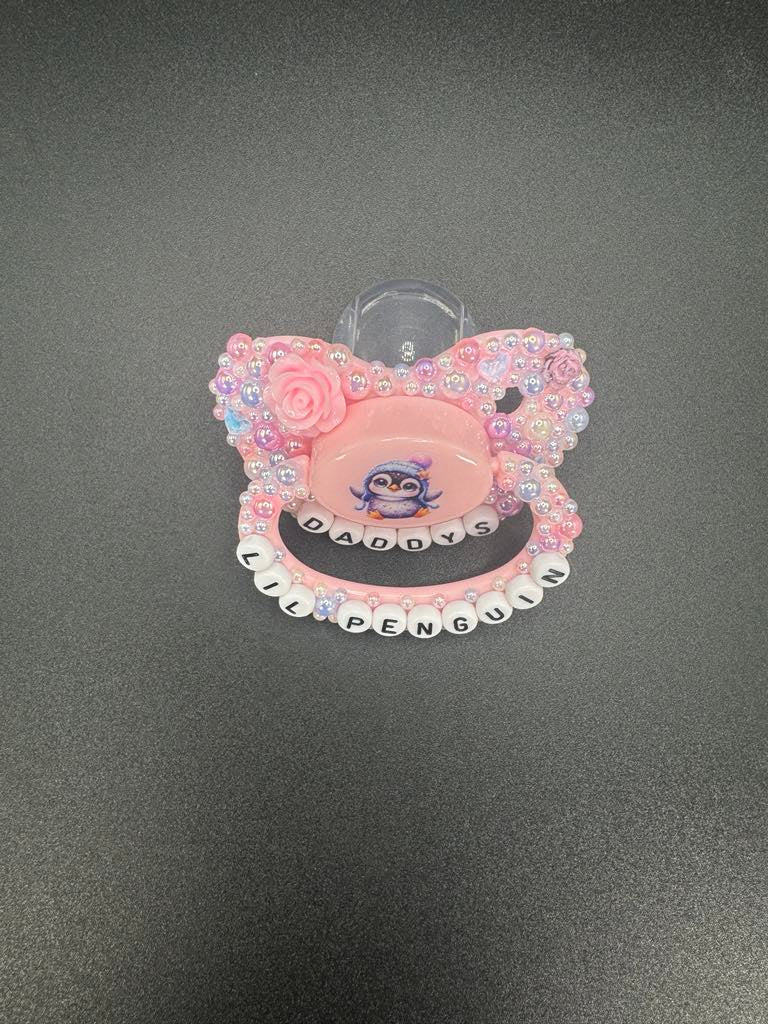 Handmade Penguin Adult Deco Pacifier with pearl decorations and 'Daddy's Lil Penguin' text, perfect for adding personality.
