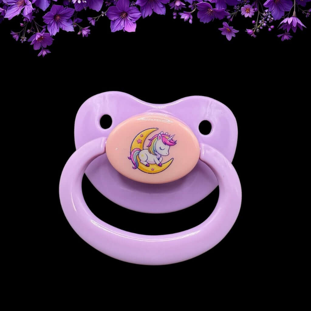Enjoy our adorable adult pacifier featuring a Kawaii unicorn sitting on the moon in the center with the option to add your own custom text to the handle.
