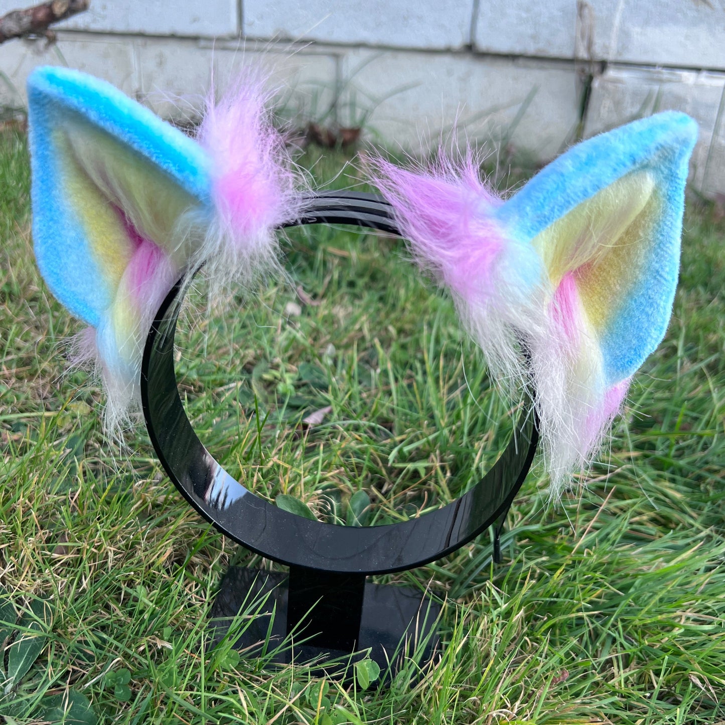 Kitten costume ears with pansexual pride flag colors. Blue is the main color on the back with pink being the color for the longer fur in the back. The front is blue outside and yellow and then pink for the inner ear.
