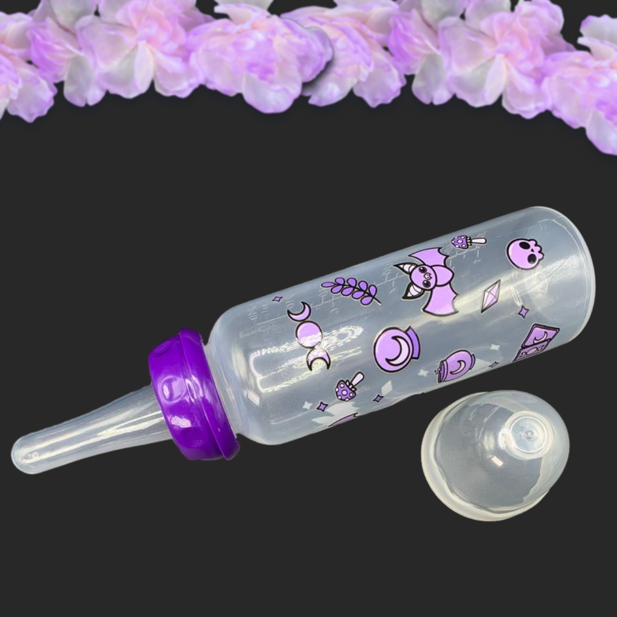 An 8oz adult baby bottle with a purple witch theme, featuring magical designs like bats, tarot cards, potions, stars, and moons wrapping around the bottle for a whimsical and enchanting look.