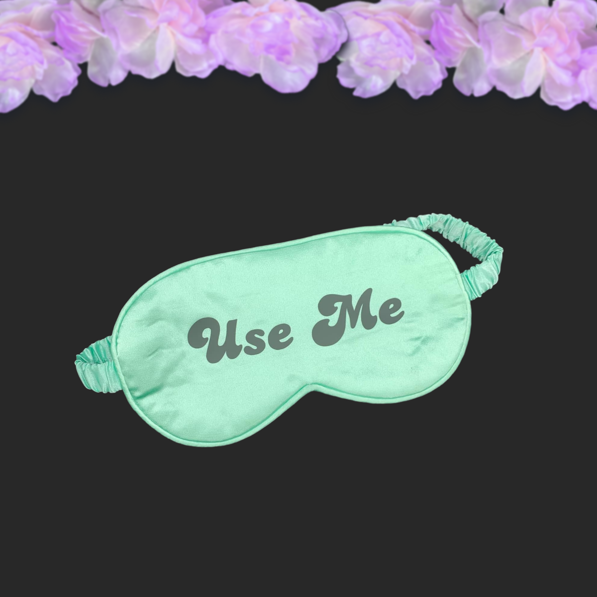 green silky satin eye mask with black text reading use me
