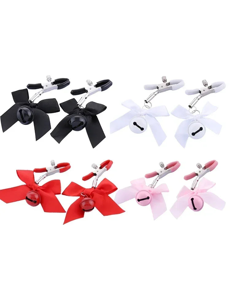 Stainless steel nipple clamps with attached bows and bells at the ends, featuring a silicone cover for added comfort and a stylish, playful touch.