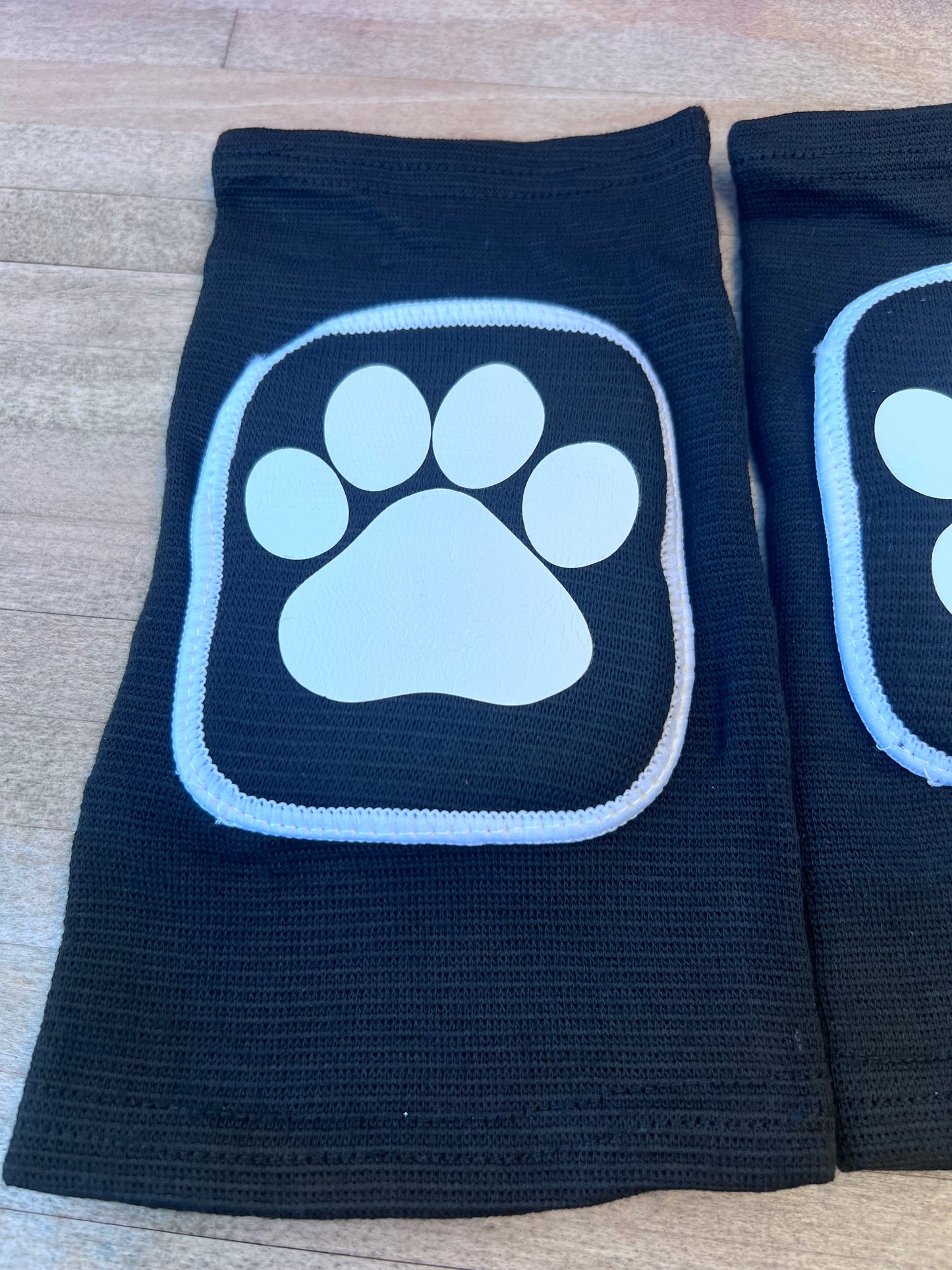 Adult knee pads featuring a cozy design with a paw print on each knee, perfect for pet play or adding a cute animal-themed touch.