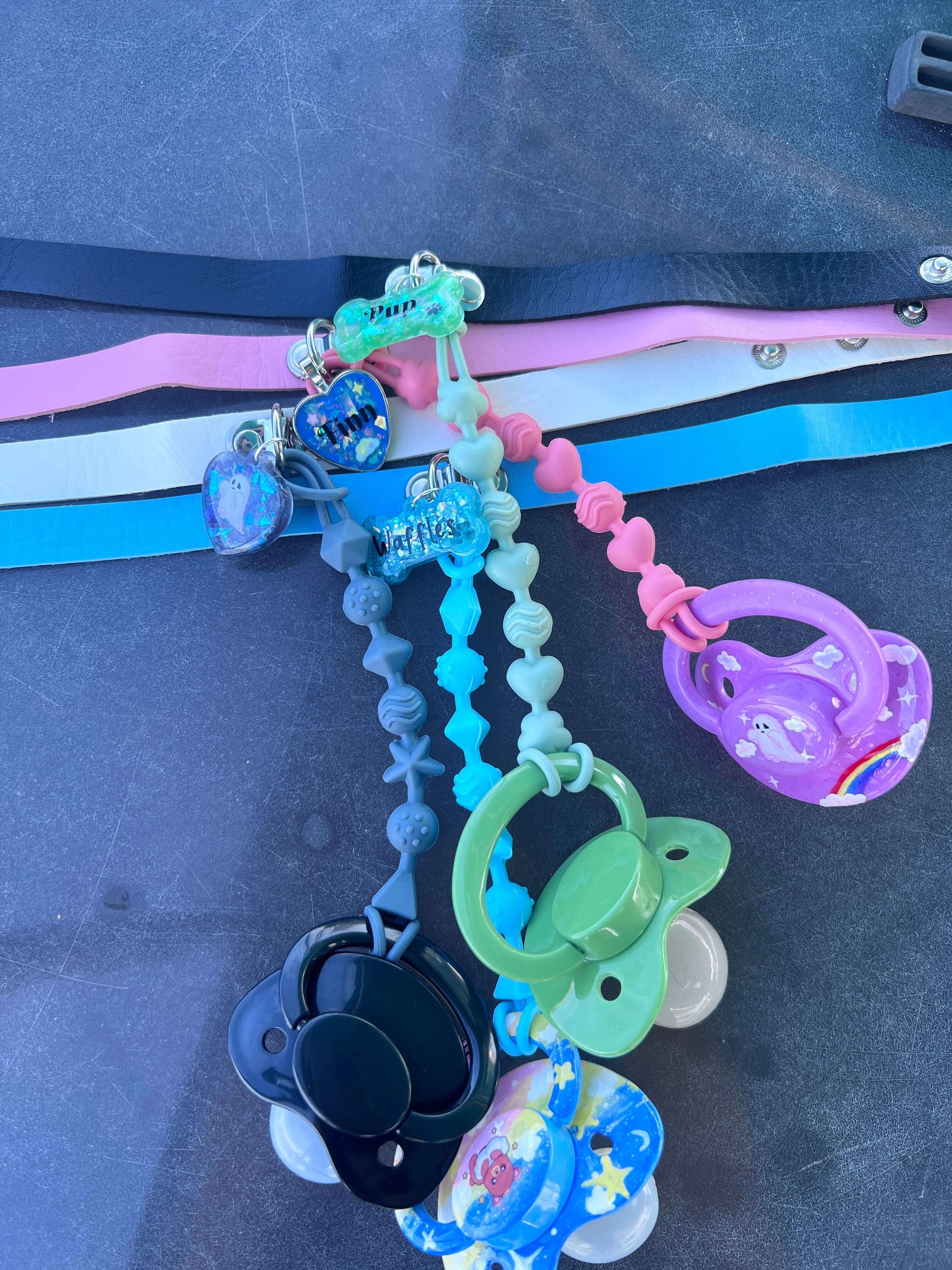 Custom adult pacifier choker featuring a leather choker, an attached adult pacifier, and a customizable resin dog tag for a personalized touch.