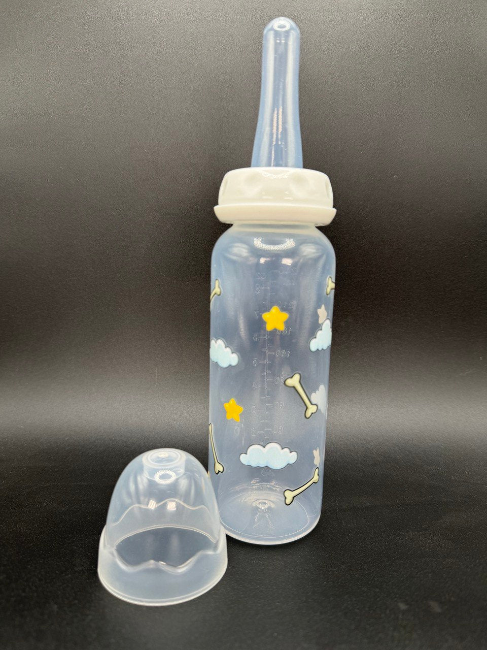 Nighttime dog-themed adult baby bottle featuring a wrap-around design of dog bones, fluffy clouds, and twinkling stars, creating a cozy and comforting aesthetic.