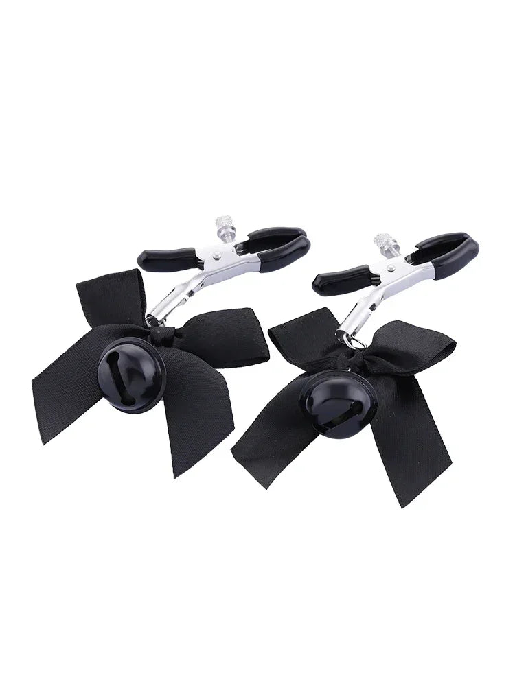 Stainless steel nipple clamps with attached bows and bells at the ends, featuring a silicone cover for added comfort and a stylish, playful touch.
