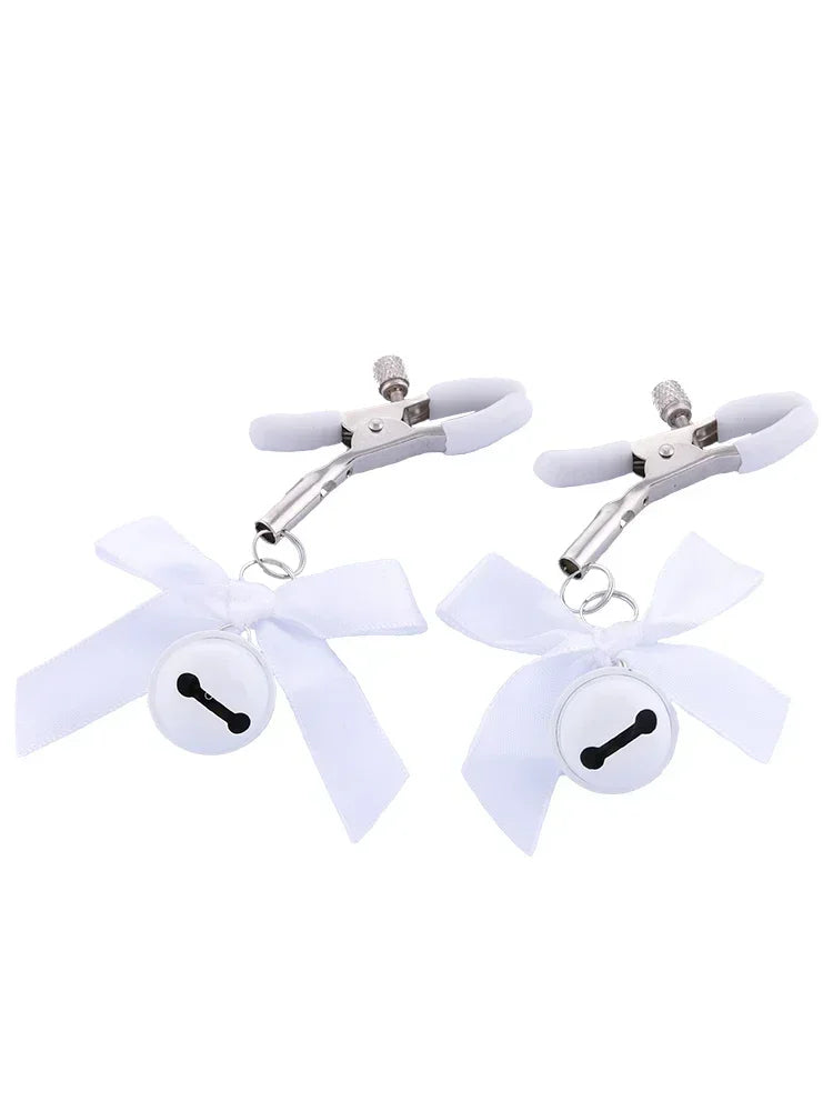 Stainless steel nipple clamps with attached bows and bells at the ends, featuring a silicone cover for added comfort and a stylish, playful touch.