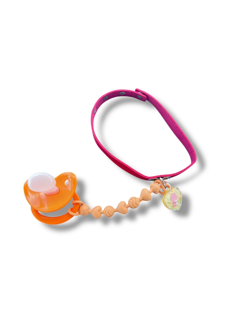 Adult baby pacifier necklace featuring red choker and glitter resin tag with red dino