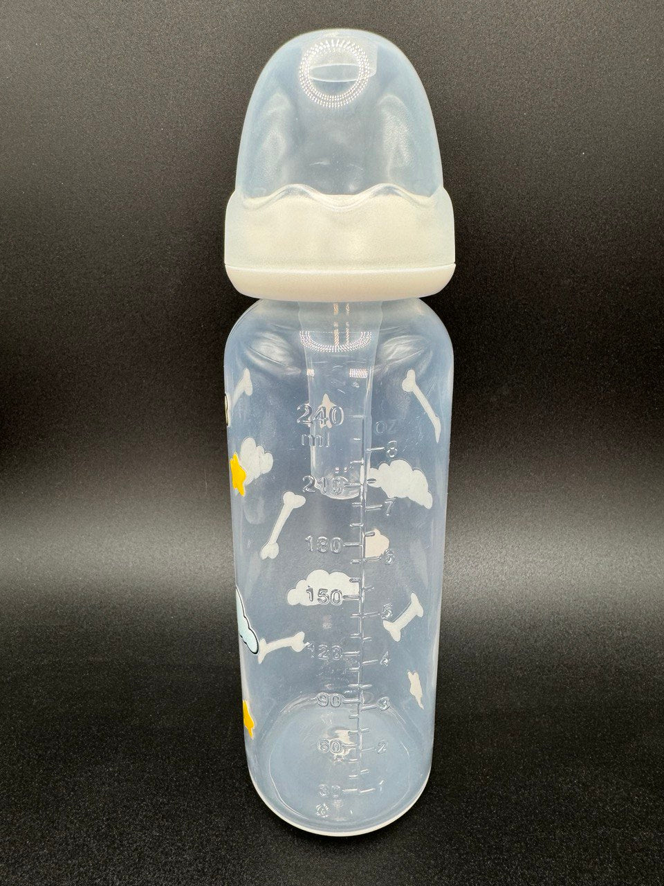 Nighttime dog-themed adult baby bottle featuring a wrap-around design of dog bones, fluffy clouds, and twinkling stars, creating a cozy and comforting aesthetic.