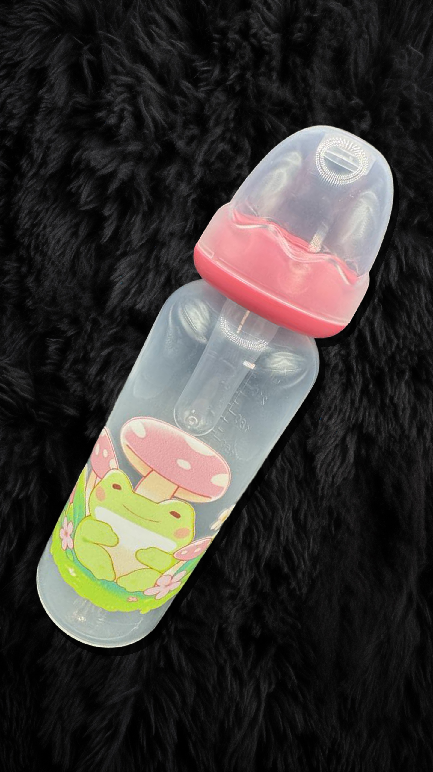 An 8oz adult baby bottle featuring a whimsical frog and mushroom theme, with cute frogs lounging among vibrant mushrooms and greenery, wrapping around the bottle.
