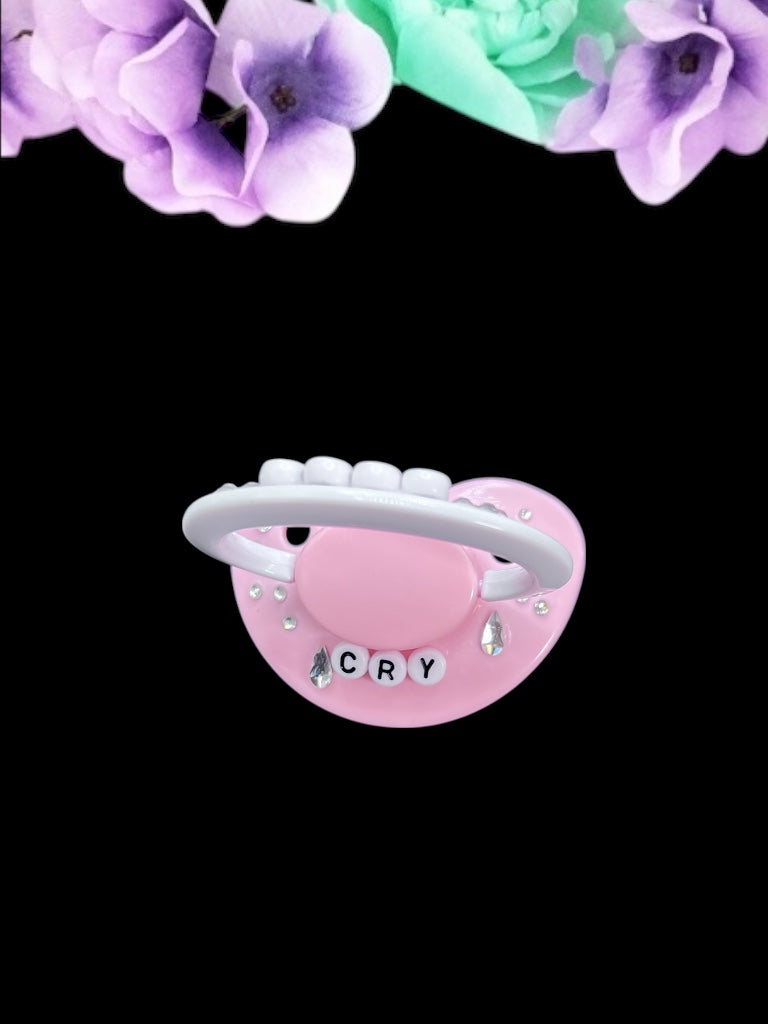 Cry Baby adult deco pacifier featuring a decorative diamond gem design on the shield and handle, adding a stylish and playful touch.