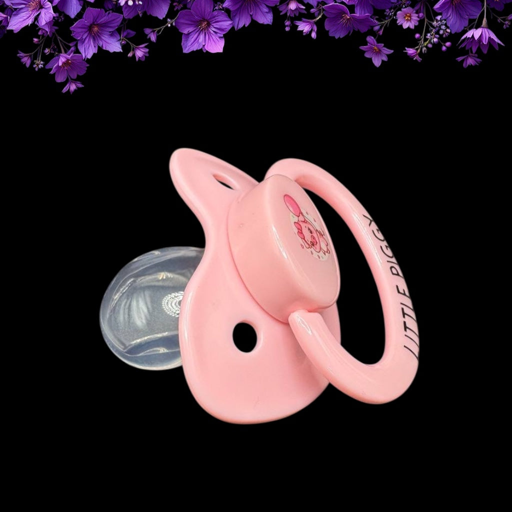 side view of baby pink adult pacifier with pig holding balloon with a cute bow on the button