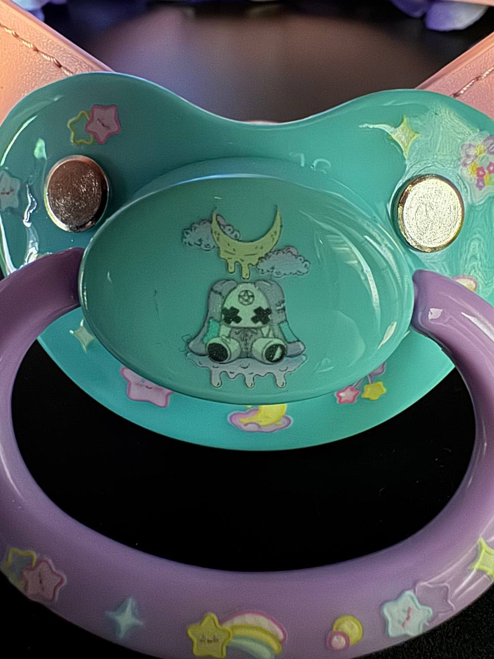 darker view of glow in the dark bunny pacifier gag