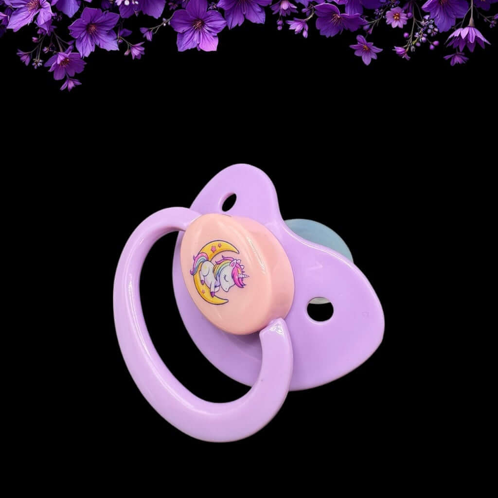 Enjoy our adorable adult pacifier featuring a Kawaii unicorn sitting on the moon in the center with the option to add your own custom text to the handle.