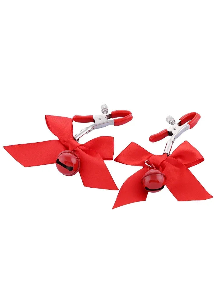 Stainless steel nipple clamps with red attached bows and bells at the ends, featuring a silicone cover for added comfort and a stylish, playful touch.
