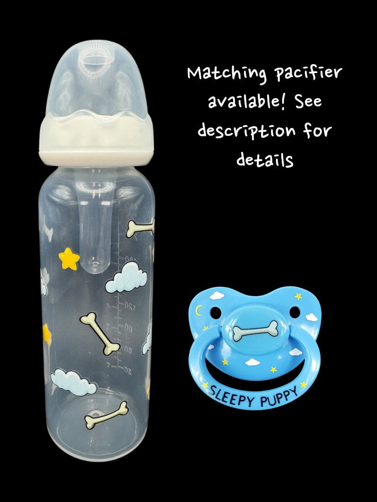 Nighttime dog-themed adult baby bottle featuring a wrap-around design of dog bones, fluffy clouds, and twinkling stars, creating a cozy and comforting aesthetic.