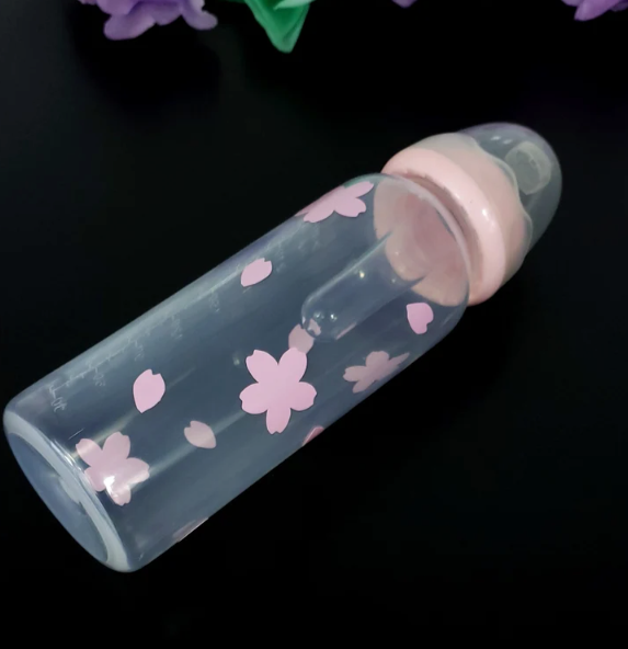 An 8oz adult baby bottle featuring a delicate sakura cherry blossom theme, with soft pink flowers and petals elegantly wrapping around the bottle for a serene and charming design.
