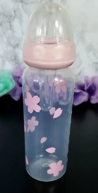 An 8oz adult baby bottle featuring a delicate sakura cherry blossom theme, with soft pink flowers and petals elegantly wrapping around the bottle for a serene and charming design.