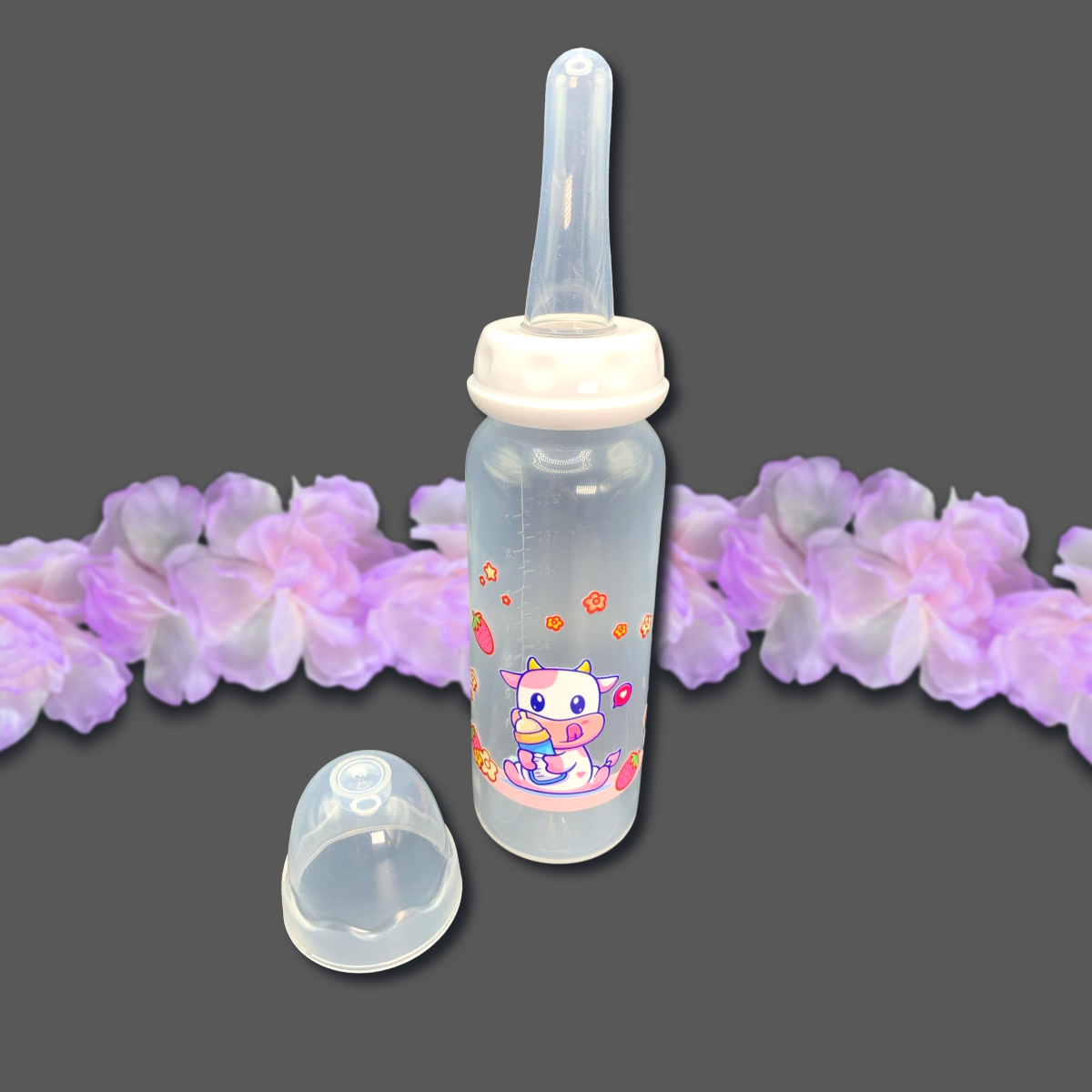 An 8oz adult baby bottle featuring a cute strawberry cow theme, with a playful pink cow, flowers, and strawberries wrapped around the bottle, creating an adorable and sweet design.