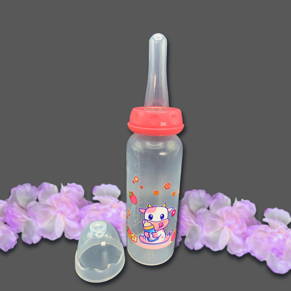 An 8oz adult baby bottle featuring a cute strawberry cow theme, with a playful pink cow, flowers, and strawberries wrapped around the bottle, creating an adorable and sweet design.