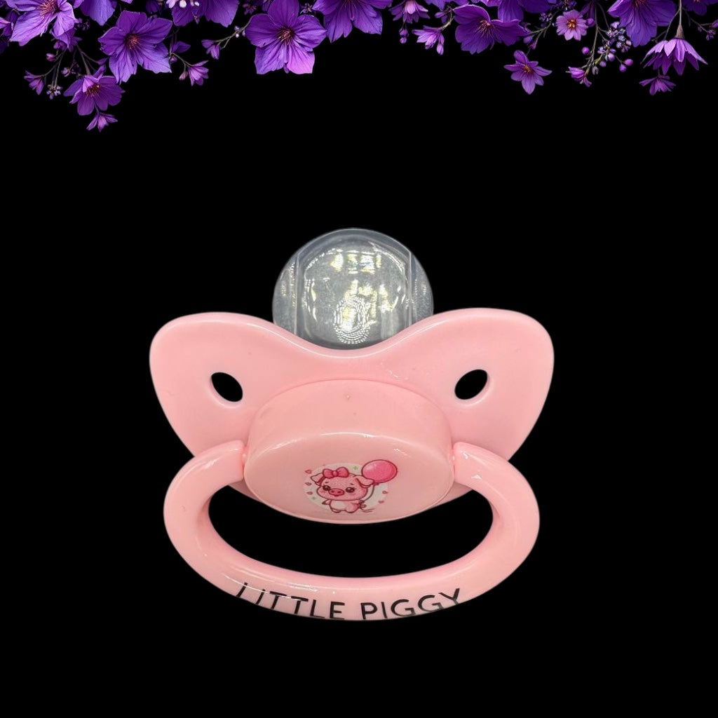 top down view of pink adult pacifier with cute pig image on button
