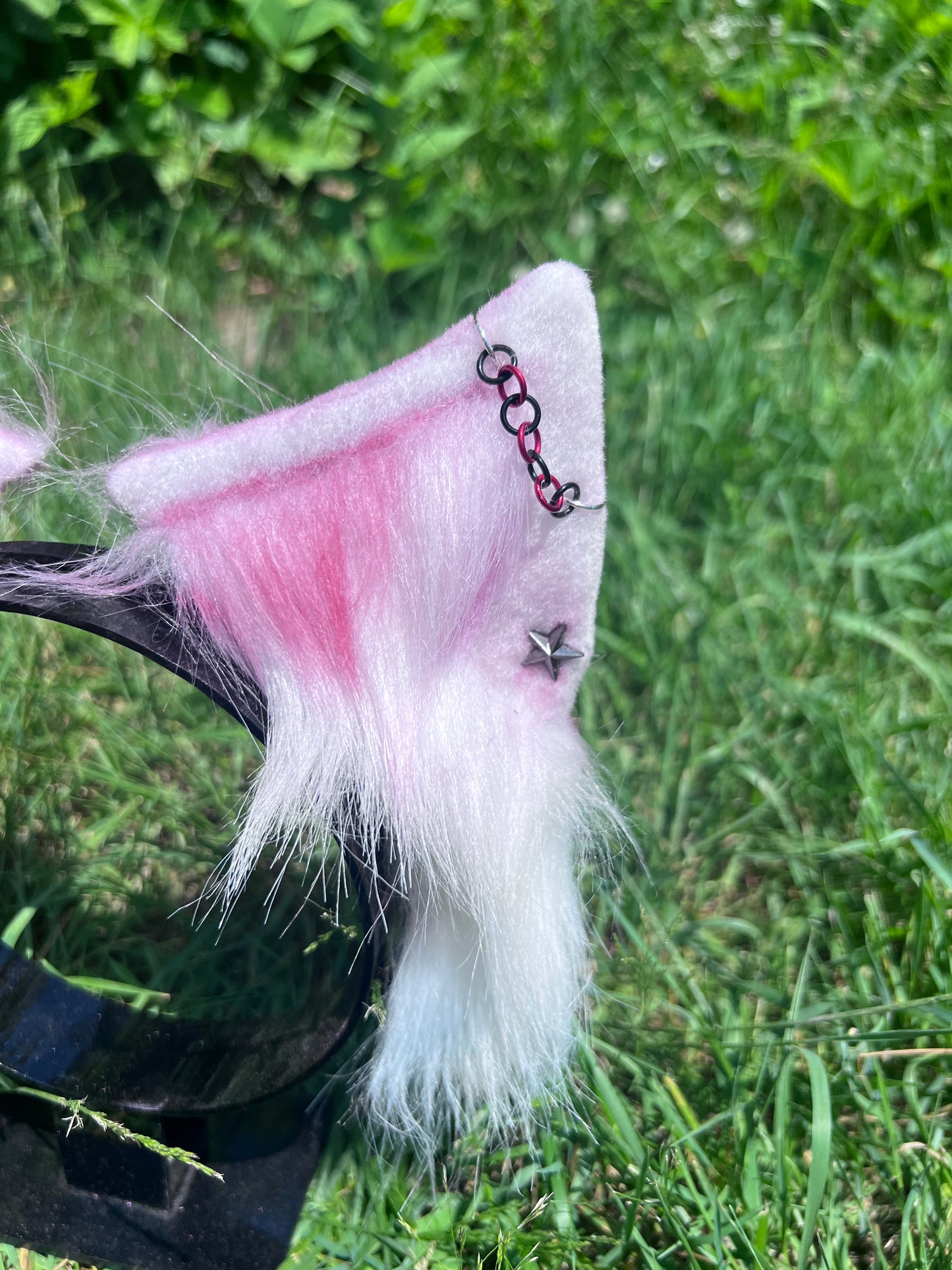 close up of white and red punk kitten ears headband featuring star earrings and red and black chain