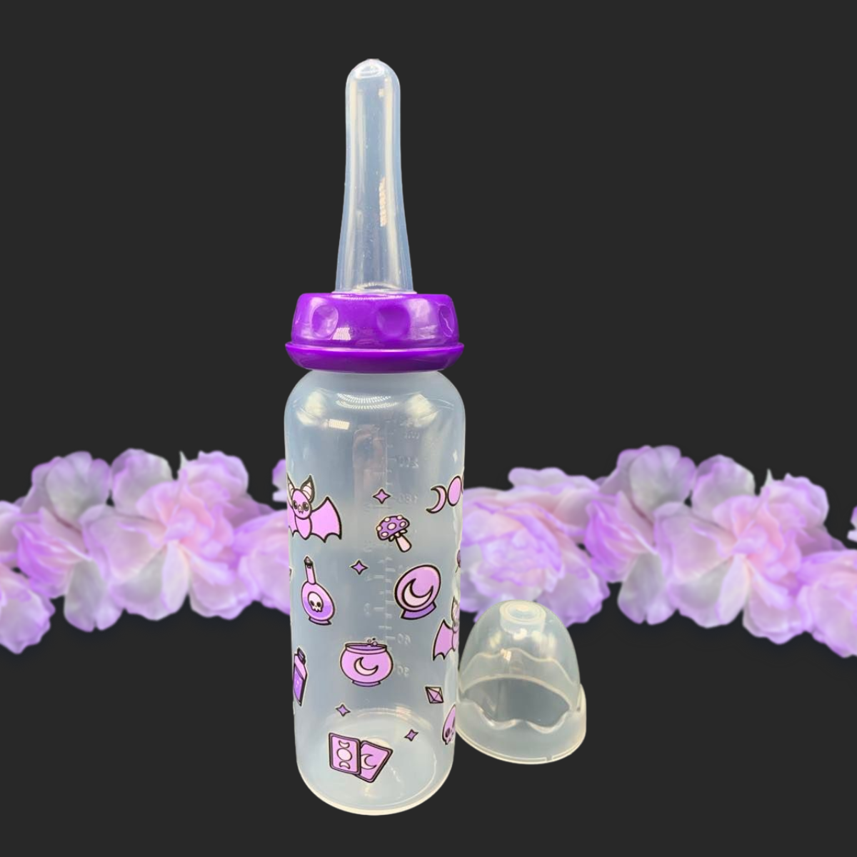 An 8oz adult baby bottle with a purple witch theme, featuring magical designs like bats, tarot cards, potions, stars, and moons wrapping around the bottle for a whimsical and enchanting look.