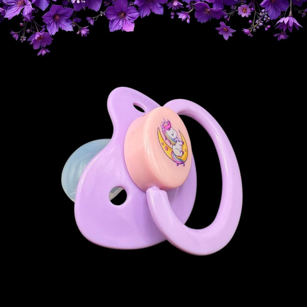 Enjoy our adorable adult pacifier featuring a Kawaii unicorn sitting on the moon in the center with the option to add your own custom text to the handle.