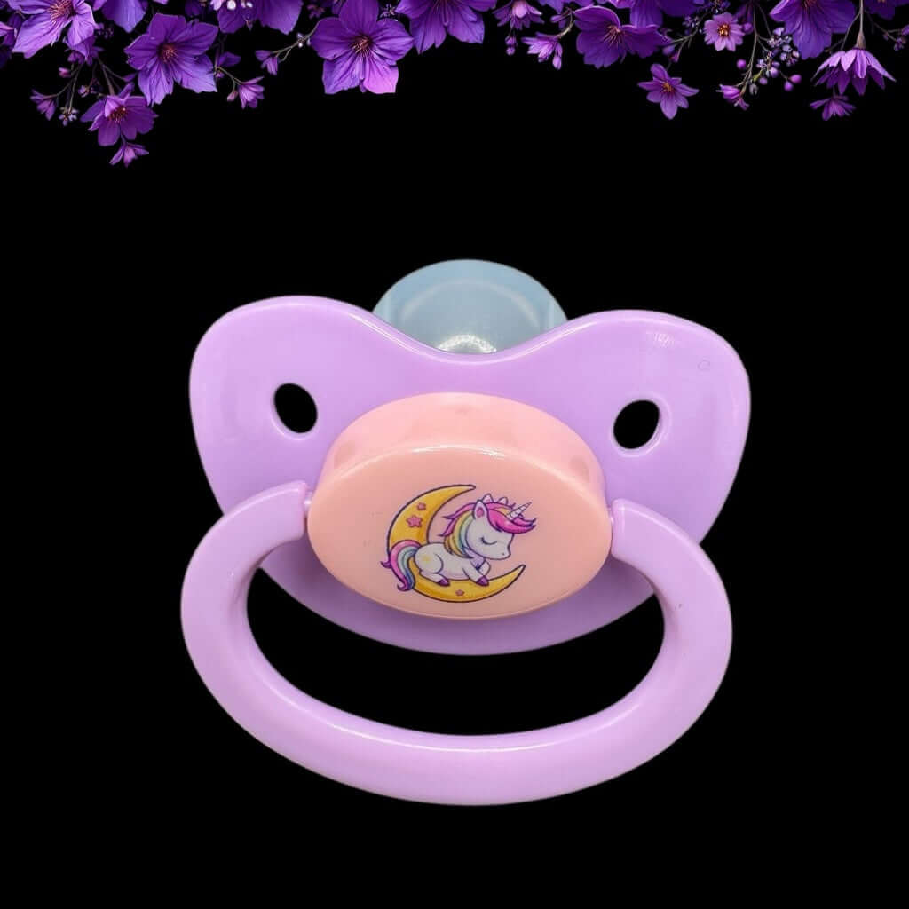 Enjoy our adorable adult pacifier featuring a Kawaii unicorn sitting on the moon in the center with the option to add your own custom text to the handle.