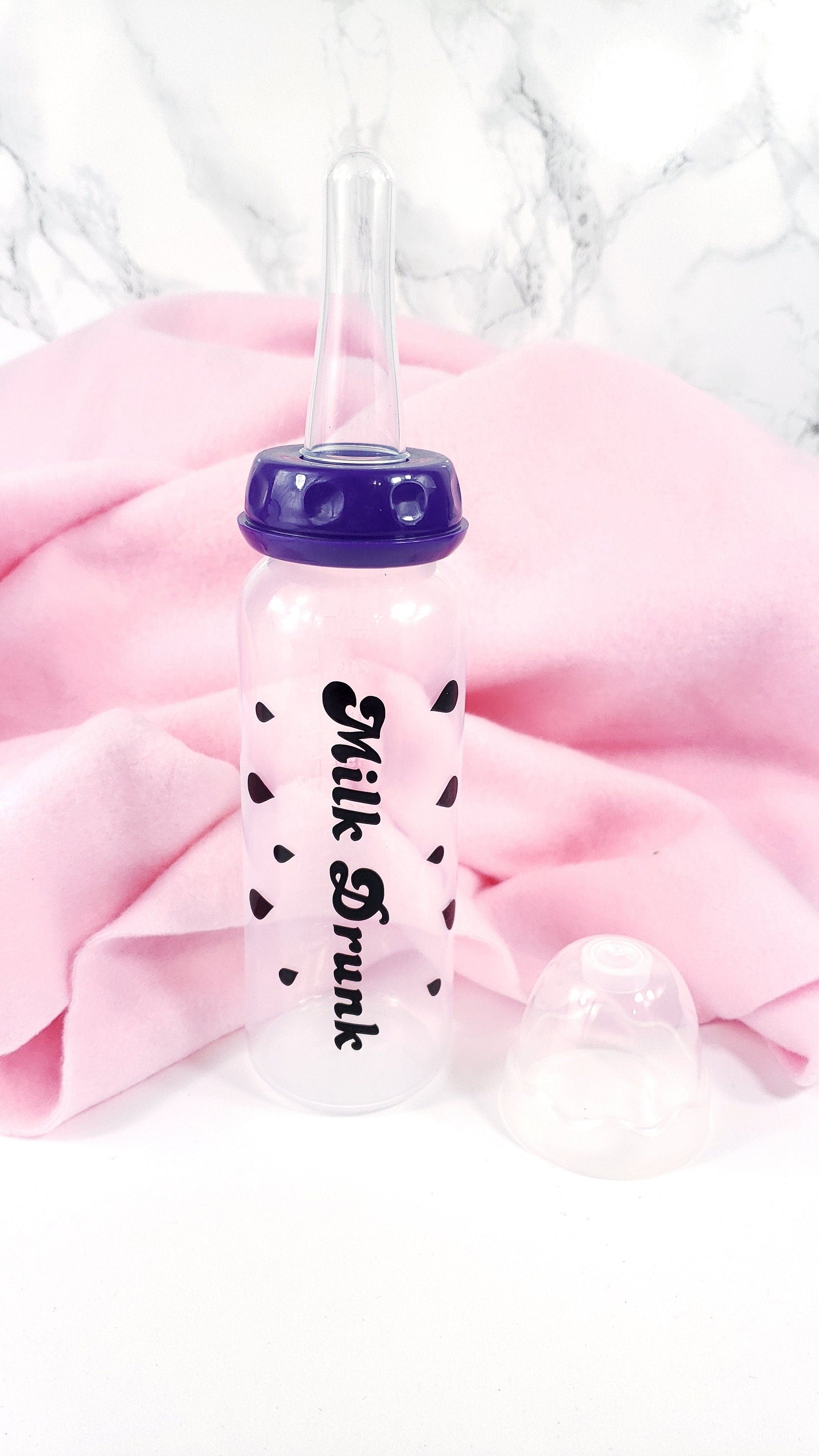 An 8oz adult baby bottle with the phrase "Milk Drunk" written in bold black text across with silhouette milk drops, offering a playful design.