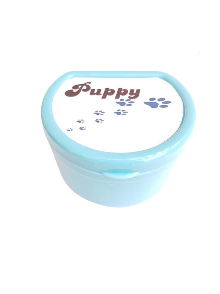 Adult pacifier case featuring the word 'Puppy' on the lid with cute paw print accents, designed for stylish and convenient pacifier storage.