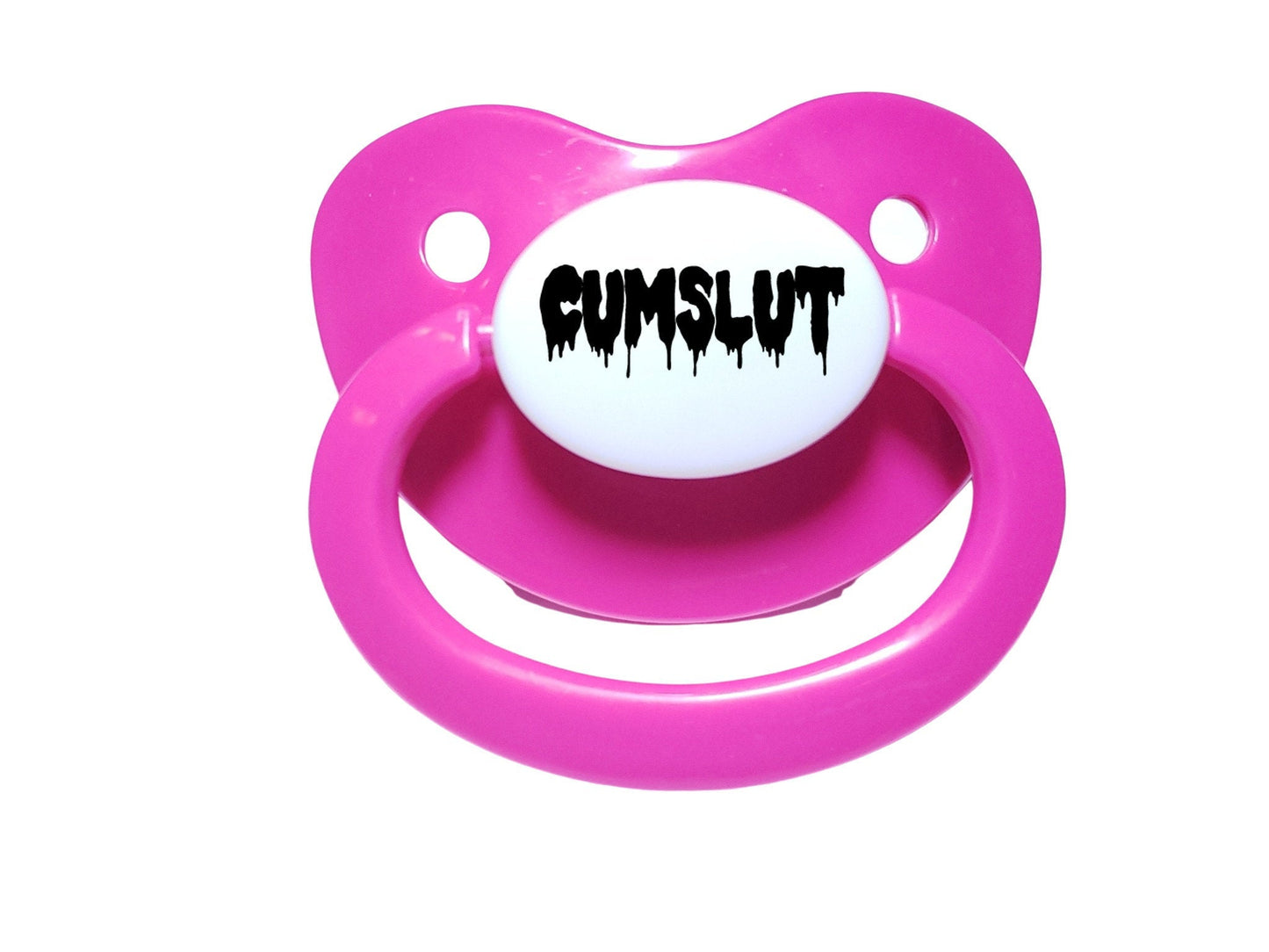 A hot pink adult pacifier featuring the word "Cumslut" boldly displayed in the center, designed for playful and cheeky self-expression.