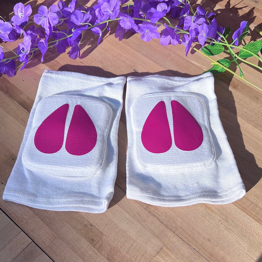 White adult knee pads with hot pink vinyl cow hooves, designed for pet play or cosplay.