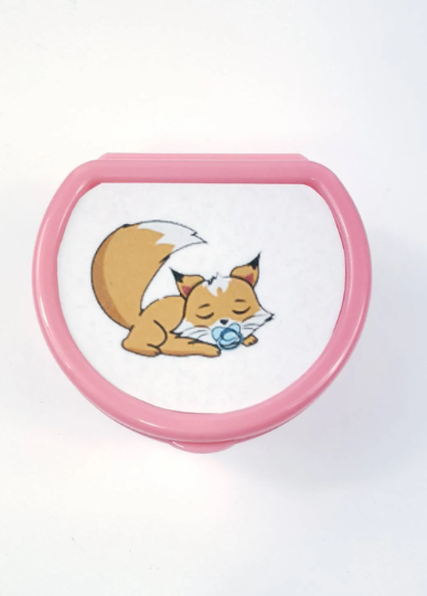 ABDL pacifier case featuring a sleeping fox with a pacifier in it's mouth on the lid, adding a dreamy and cute touch to pacifier storage.
