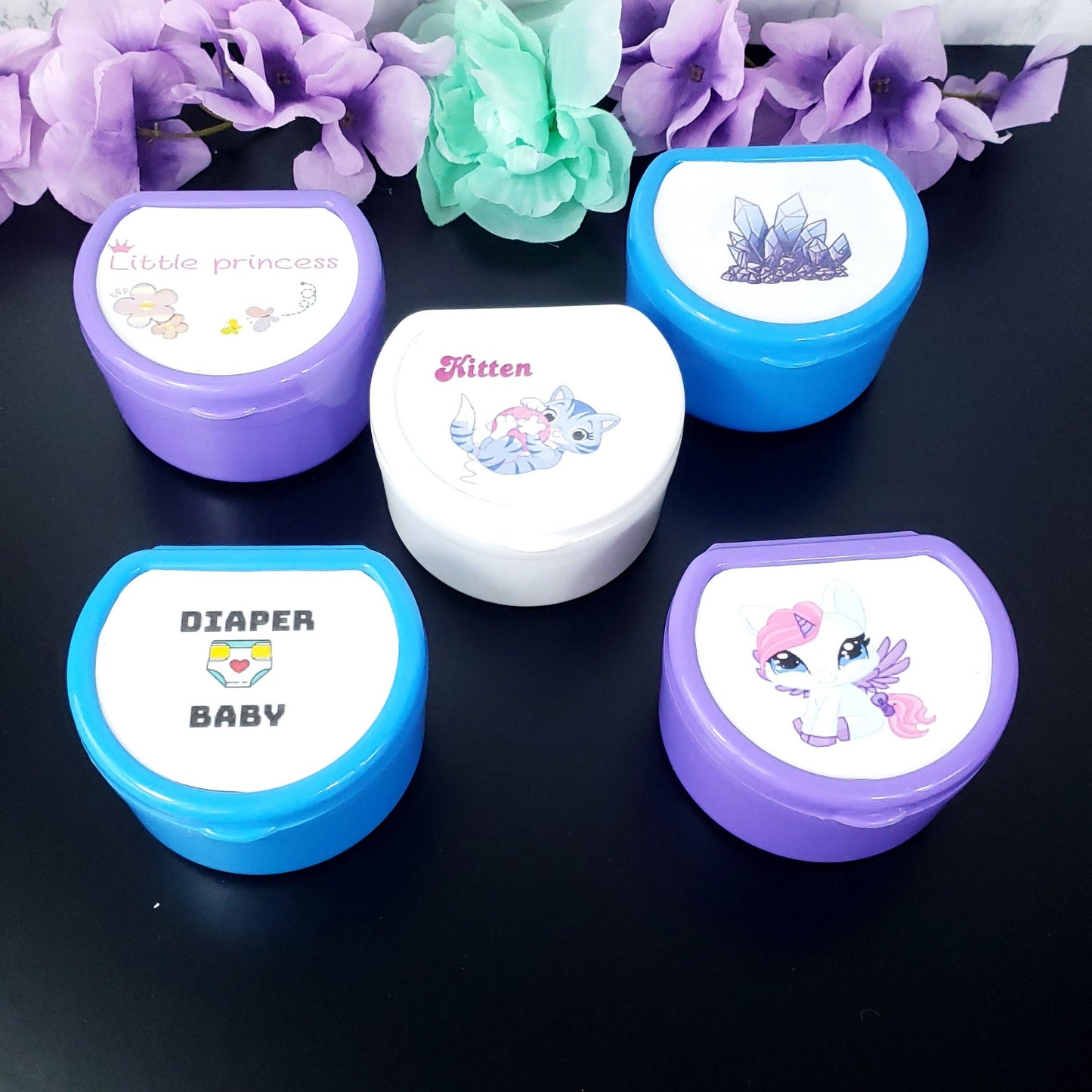 customizable adult pacifier cases in various colors with your choice of design on the top.