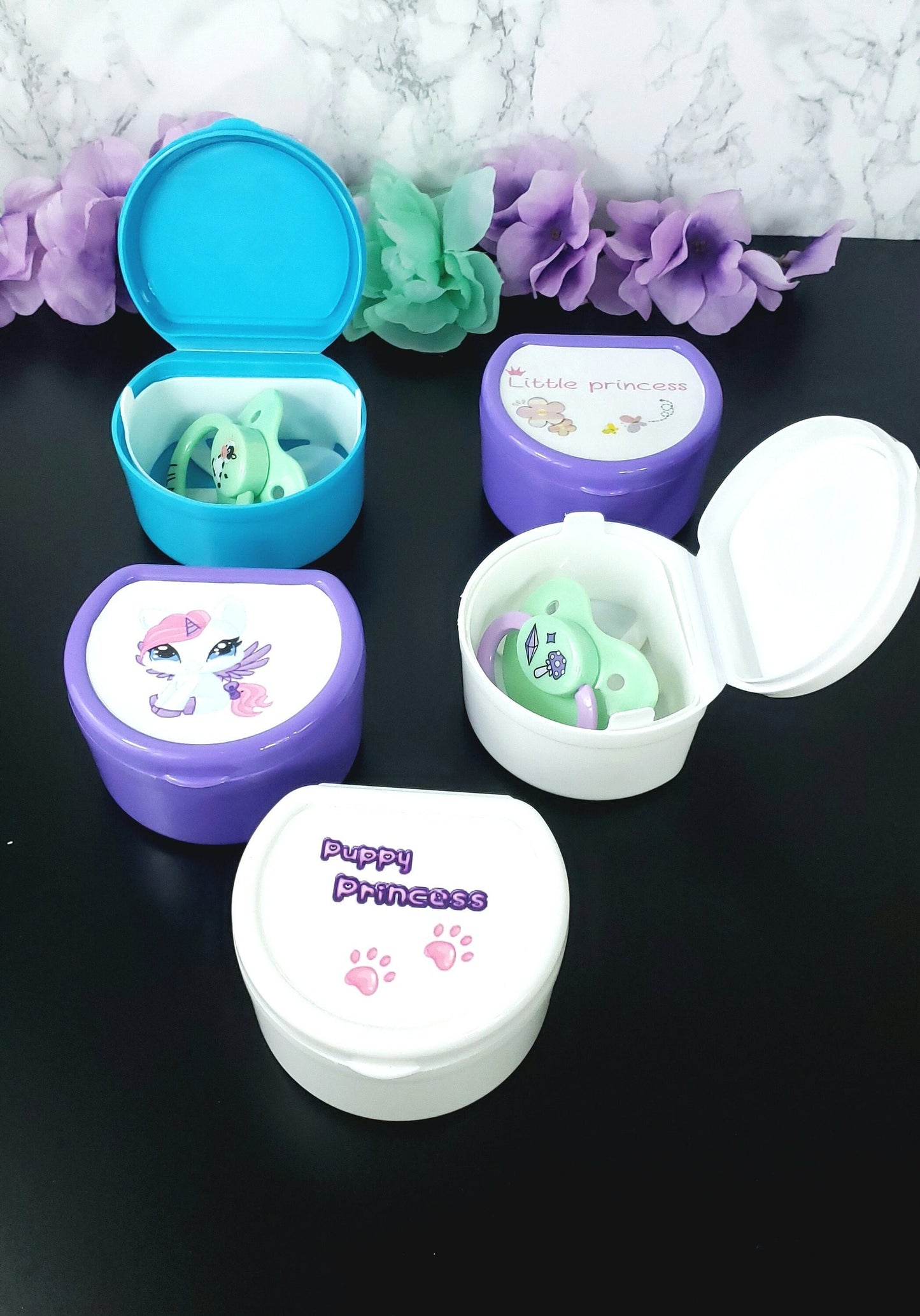 customizable adult pacifier cases in various colors with your choice of design on the top.