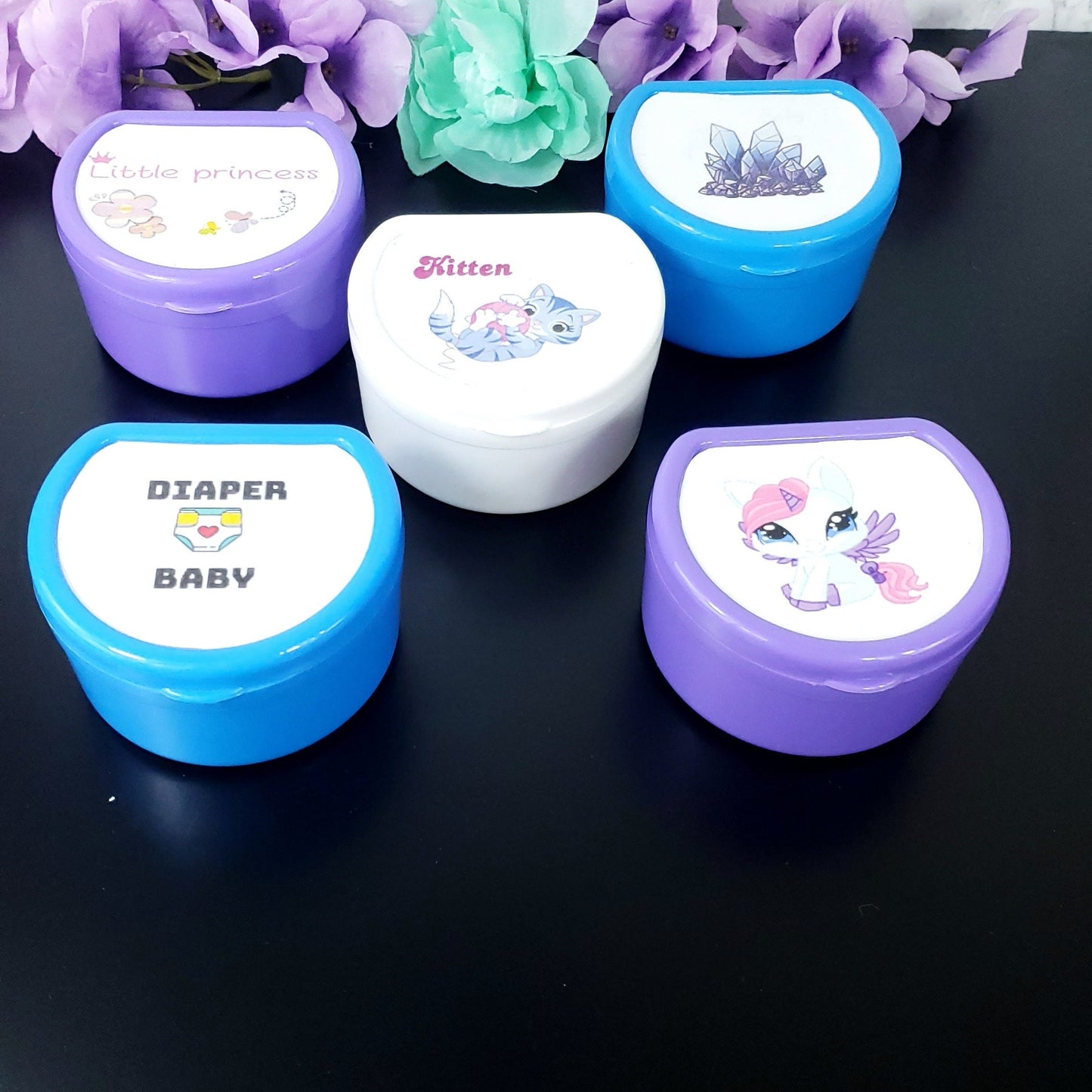 customizable adult pacifier cases in various colors with your choice of design on the top.