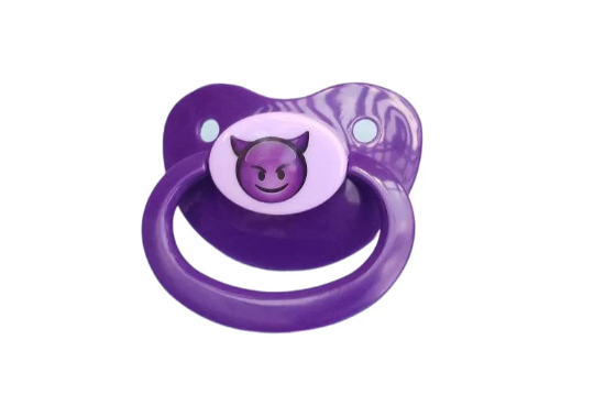 A purple and lavender adult pacifier with a center design featuring a mischievous purple devil emoji, adding a playful and edgy touch.