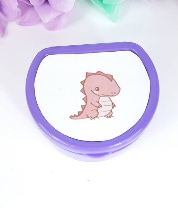 ABDL pacifier case featuring a cute red dinosaur design on the lid, adding a fun and playful touch to pacifier storage.