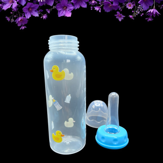 Clear adult baby bottle with rubber duck and milk bottle illustrations, accompanied by a blue cap on a black background with purple flowers.