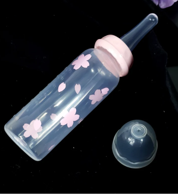 An 8oz adult baby bottle featuring a delicate sakura cherry blossom theme, with soft pink flowers and petals elegantly wrapping around the bottle for a serene and charming design.