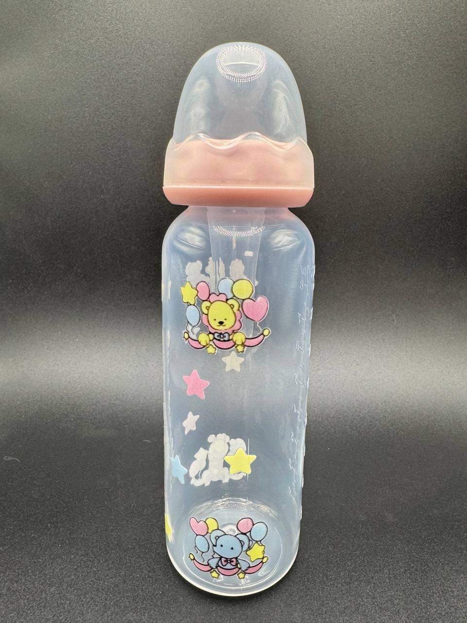 Adult Baby bottle with pastel cartoon circus designs on a dark background