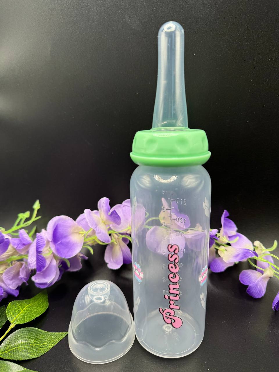 Clear adult baby bottle with green cap and 'Princess' text with paw prints